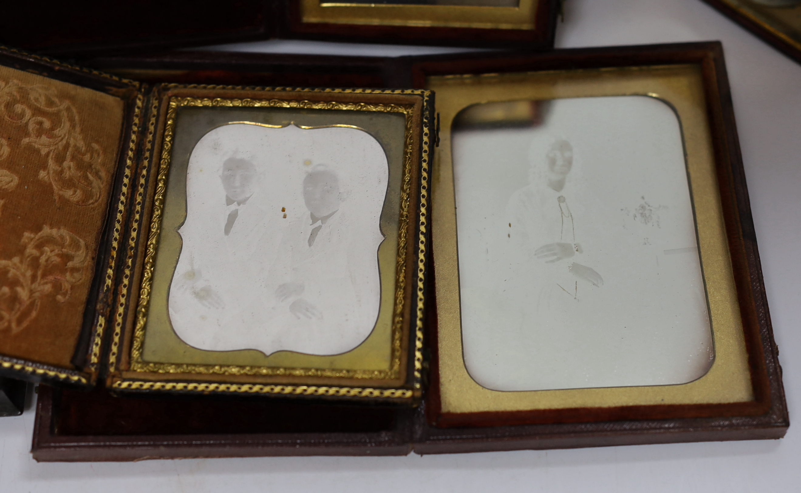 Nine mid 19th century daguerreotype portrait photographs, all mounted in brass, etc. frames, some in decorative cases, one example framed
